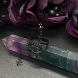 Black Snake Ring being displayed on a fluorite pointed crystal.