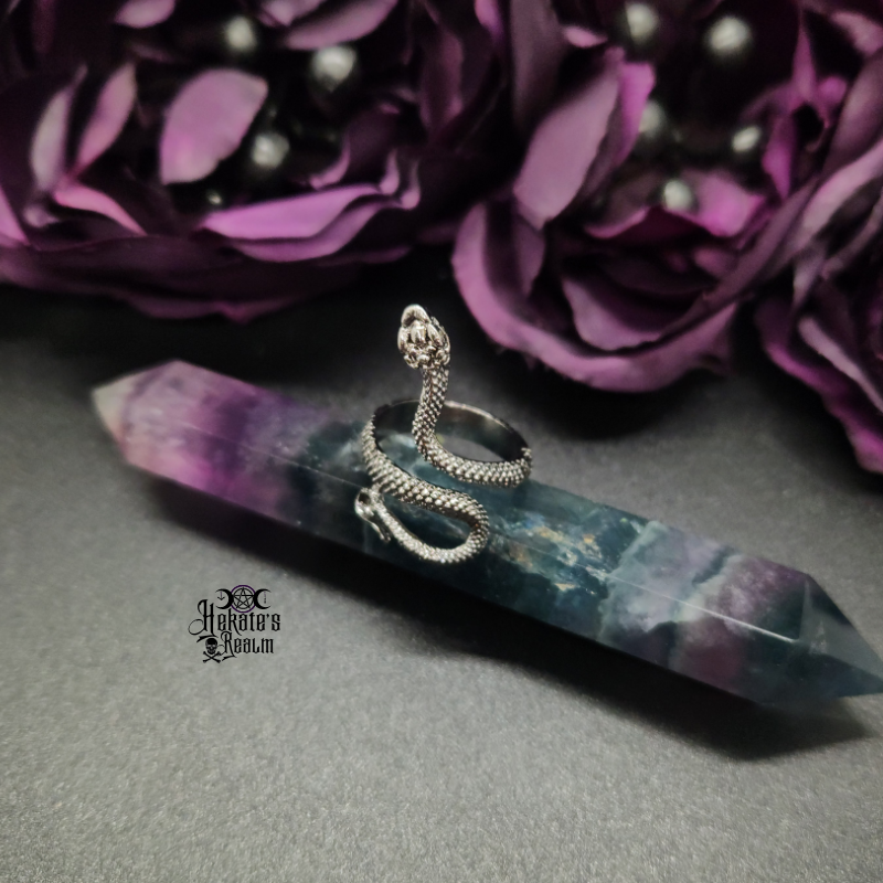 Gunmetal Snake Ring being displayed on a fluorite pointed crystal.